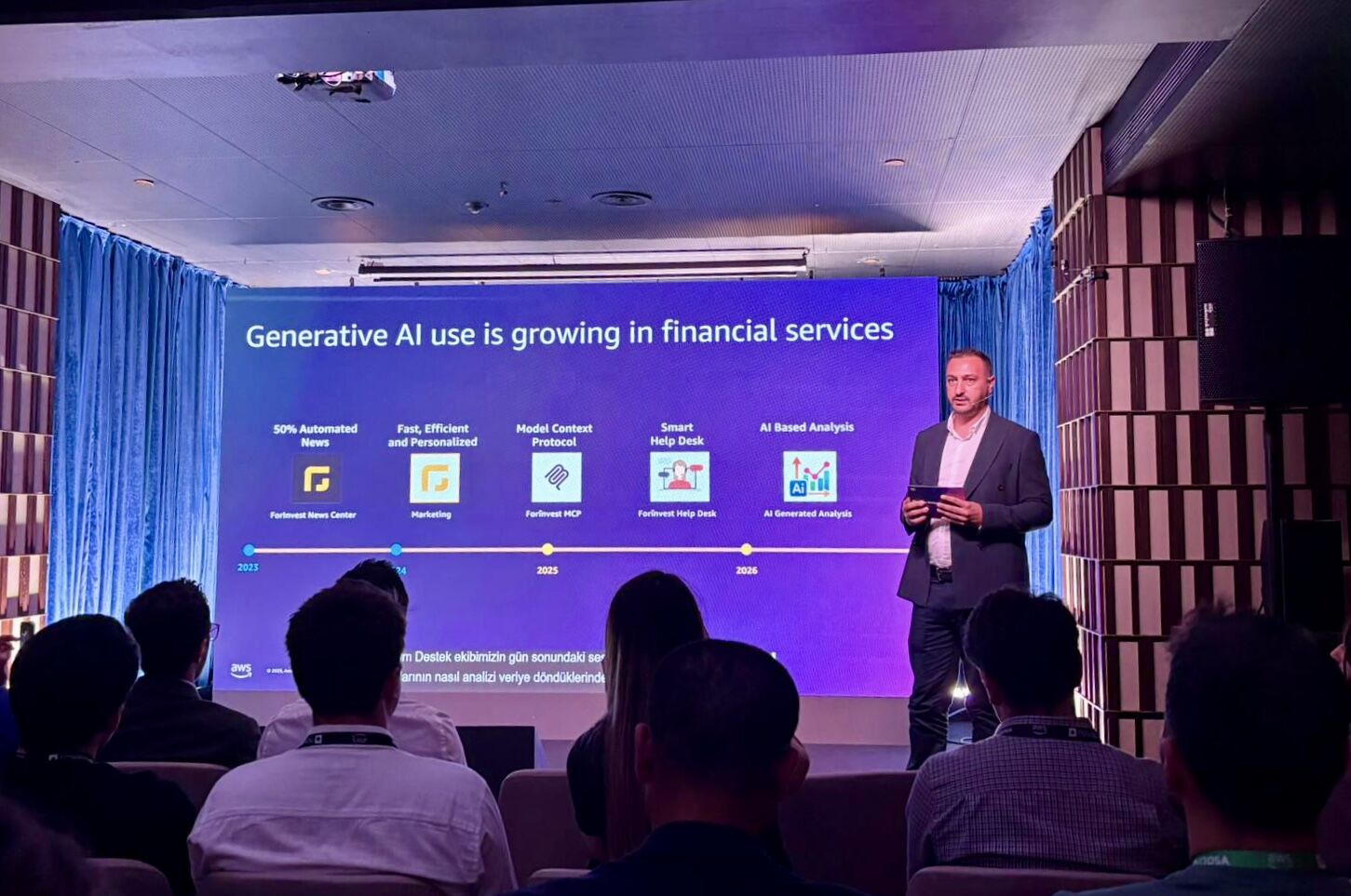 Emre Toprak presenting on stage at AWS Cloud Day Istanbul